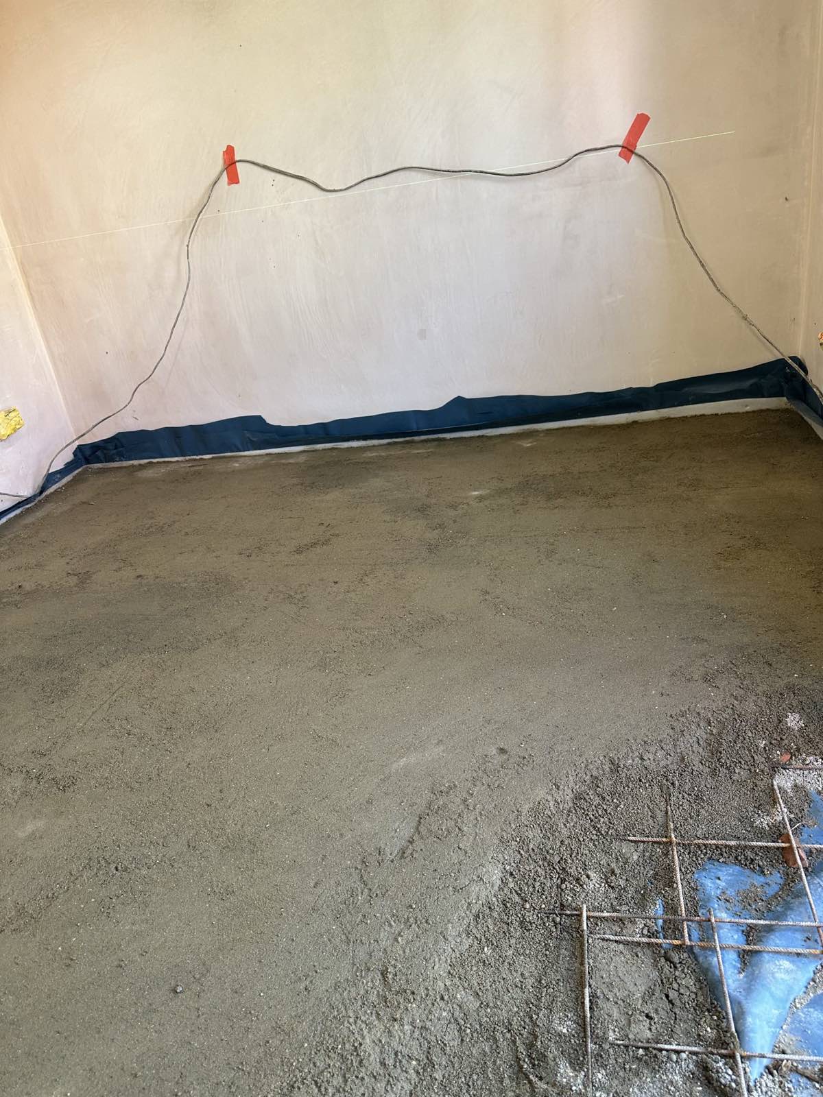 Screed being levelled in a garage conversion floor, Hendon NW4
