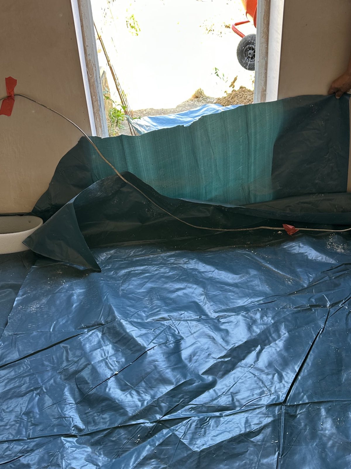 Damp proof membrane being laid in a garage conversion, Hendon NW4