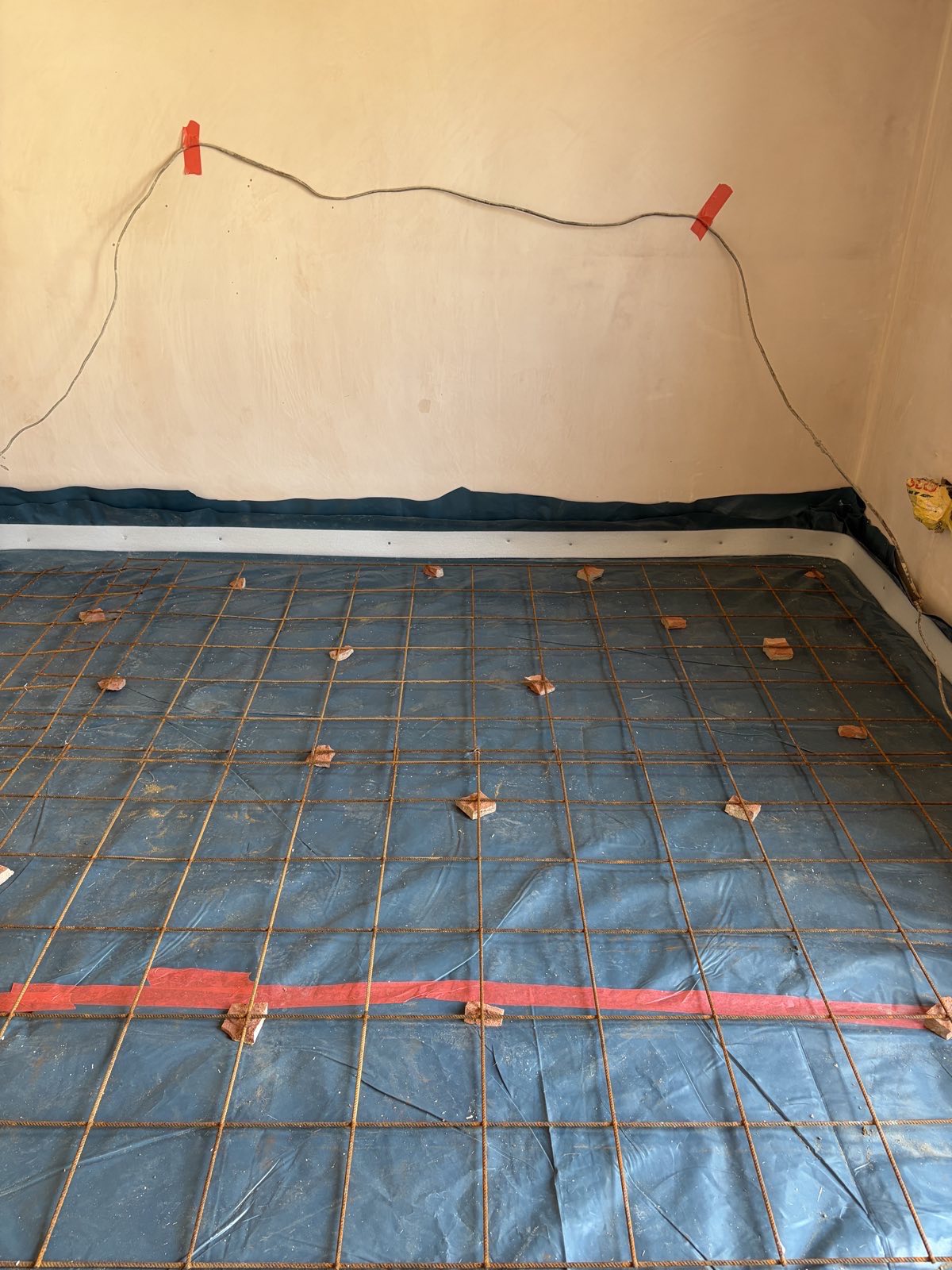 Steel reinforcement mesh raised on spacers over a damp proof membrane, garage conversion Hendon NW4